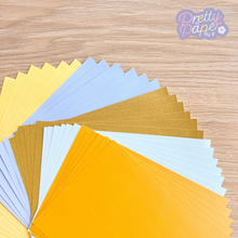 Load image into Gallery viewer, buttercup, swallow blue, pale gold sparkle, pastel blue and amber pearl papers