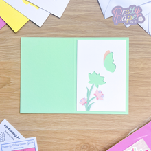 Load image into Gallery viewer, butterfly and flower aperture on turquoise card blank