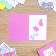 Load image into Gallery viewer, Butterfly and flower aperture on pink card blank