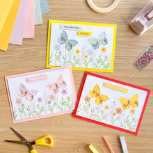 Load image into Gallery viewer, Three greeting cards with iris folding butterfly designs on a wooden surface with crafting supplies.
