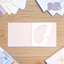 Load image into Gallery viewer, butterfly wing aperture on blush pink card blank