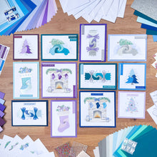 Load image into Gallery viewer, Collection of Christmas-themed greeting cards and decorative items on a wooden surface.