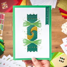 Load image into Gallery viewer, Handmade card with decorative elements on a wooden surface