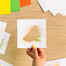 Load image into Gallery viewer, Hand holding a citrus fruit aperture with a colourful background