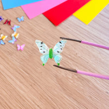 Load image into Gallery viewer, Colorful butterfly decorations on a wooden surface with tweezers.