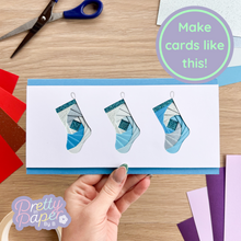 Load image into Gallery viewer, iris fold card in blue made with the three stocking aperture
