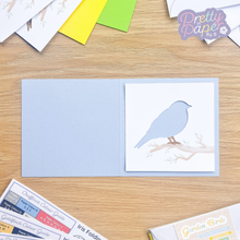 Load image into Gallery viewer, Bird aperture on blue card blank