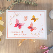 Load image into Gallery viewer, Box with butterflies and motivational quote on a wooden surface with decorative elements.