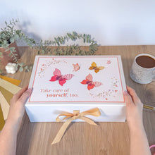 Load image into Gallery viewer, White gift box with butterfly design and 'Take care of yourself, too.' text on a wooden table.