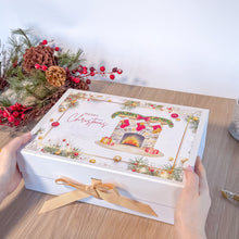 Load image into Gallery viewer, White box with Christmas Fireplace design held by hands on a wooden surface