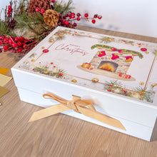 Load image into Gallery viewer, Decorative Christmas box with festive design and gold ribbon on a wooden surface.