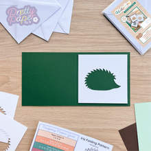 Load image into Gallery viewer, white hedgehog aperture on dark green card blank