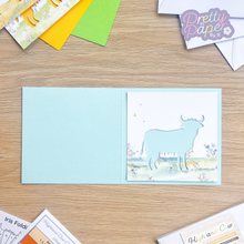 Load image into Gallery viewer, Highland Cow Card Aperture on blue card
