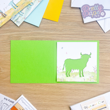 Load image into Gallery viewer, Highland Cow Card Aperture on green card
