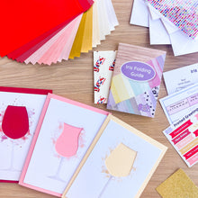 Load image into Gallery viewer, Collection of paper craft supplies and an iris folding guide on a wooden surface