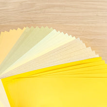 Load image into Gallery viewer, Close up of thirty sheets of A5 paper in 5 different yellow/gold/cream shades