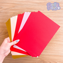 Load image into Gallery viewer, Thirty sheets of red and rose gold coloured papers