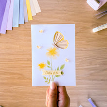 Load image into Gallery viewer, An iris fold butterfly card with printed yellow flowers and resin butterfly embellishments and Thinking of You text