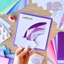 Load image into Gallery viewer, An iris folding rainbow curve in purple with two white paper clouds and a &#39;with love&#39; greeting
