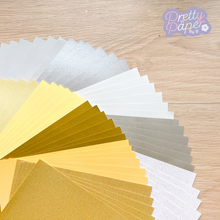 Load image into Gallery viewer, 60 sheets of A5 plain, pearl and sparkle paper (6 each of 10 colours: silver, grey, gold, white shades)