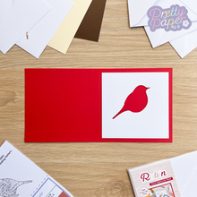 Load image into Gallery viewer, Robin aperture card pack - white aperture against red card
