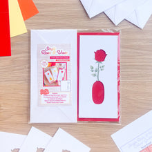 Load image into Gallery viewer, Card aperture pack with rose and vase design on a wooden surface