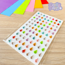 Load image into Gallery viewer, Colorful gemstone stickers on a clear sheet with 'Pretty Paper' branding.