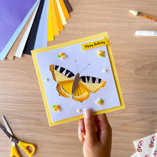Load image into Gallery viewer, An example of an iris fold butterfly greeting card made with the aperture and card blank and embellished with resin flowers and leaves and 'Happy Birthday' text