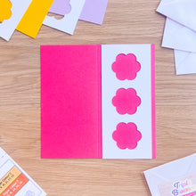 Load image into Gallery viewer, Pink card with flower designs on a wooden surface
