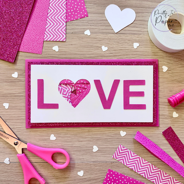 the word LOVE on a card in pink