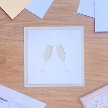 Load image into Gallery viewer, A cut-out of two champagne glasses on  a silver grey card blank 
