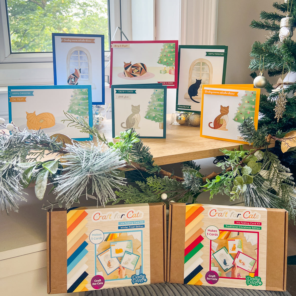 Six cats Christmas cards displayed alongside two card making kits