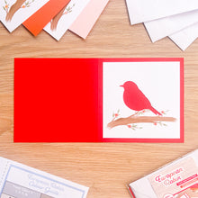 Load image into Gallery viewer, robin aperture on red card blank
