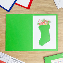 Load image into Gallery viewer, Green card with a Christmas stocking design on a wooden surface
