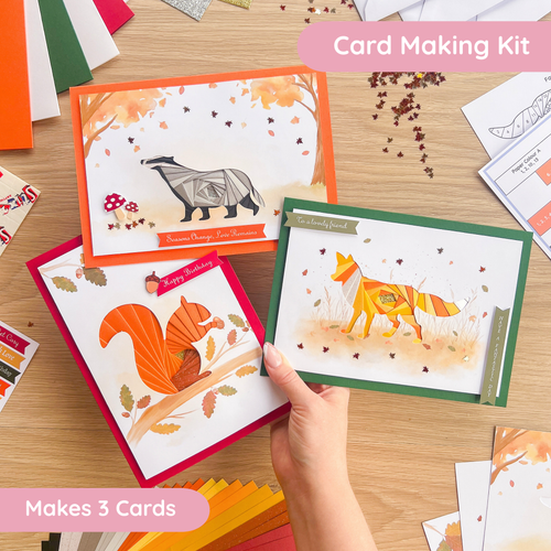 Card making kit with animal-themed cards on a wooden surface
