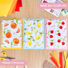Load image into Gallery viewer, Fruit Market Wall Art Craft Kit with colourful paper sheets and scissors on a wooden surface
