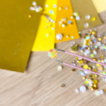 Load image into Gallery viewer, close up of yellow crystal held by tweezers

