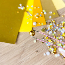 Load image into Gallery viewer, Gold pearl held by tweezers
