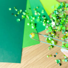 Load image into Gallery viewer, Close-up of a yellow-green gem held with tweezers
