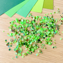 Load image into Gallery viewer, Green pearl gems and green paper on a wooden surface
