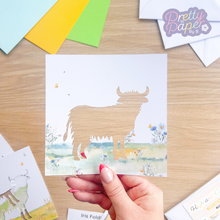 Load image into Gallery viewer, Highland Cow Card Aperture with blue and white meadow embellishment
