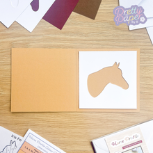 Load image into Gallery viewer, Horse card aperture on buff brown card
