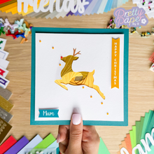 Load image into Gallery viewer, Iris Fold reindeer in gold on teal card
