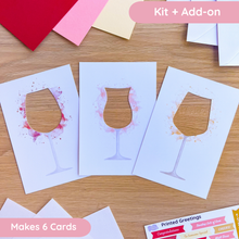 Load image into Gallery viewer, Three different wine glass cut-outs on a wooden surface with paper craft supplies

