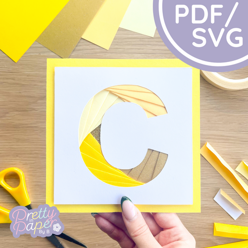 Alphabet letter C in yellow papers folded to create a spiral effect.