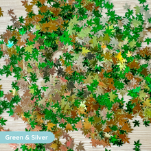Load image into Gallery viewer, Green and silver leaf confetti on a textured surface
