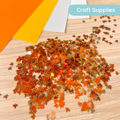 Autumn leaf craft supplies on a wooden surface