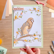 Load image into Gallery viewer, Hand holding a greeting card with a barn owl design on a wooden surface.
