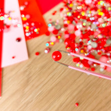 Load image into Gallery viewer, close up of tweezers holding a red pearl
