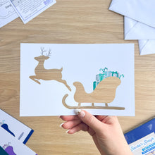 Load image into Gallery viewer, Santa&#39;s Sleigh with Reindeer Aperture Card (Pack of 3) | 3 x Square PRINTED Christmas Apertures, Coloured Card Blanks &amp; White Envelopes | Night Sky Edition | Blue Purple Teal
